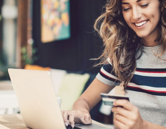 woman with credit card on laptop